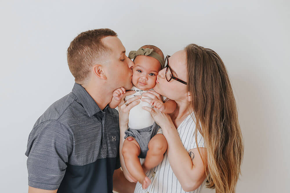 Kiersten P family kissing baby