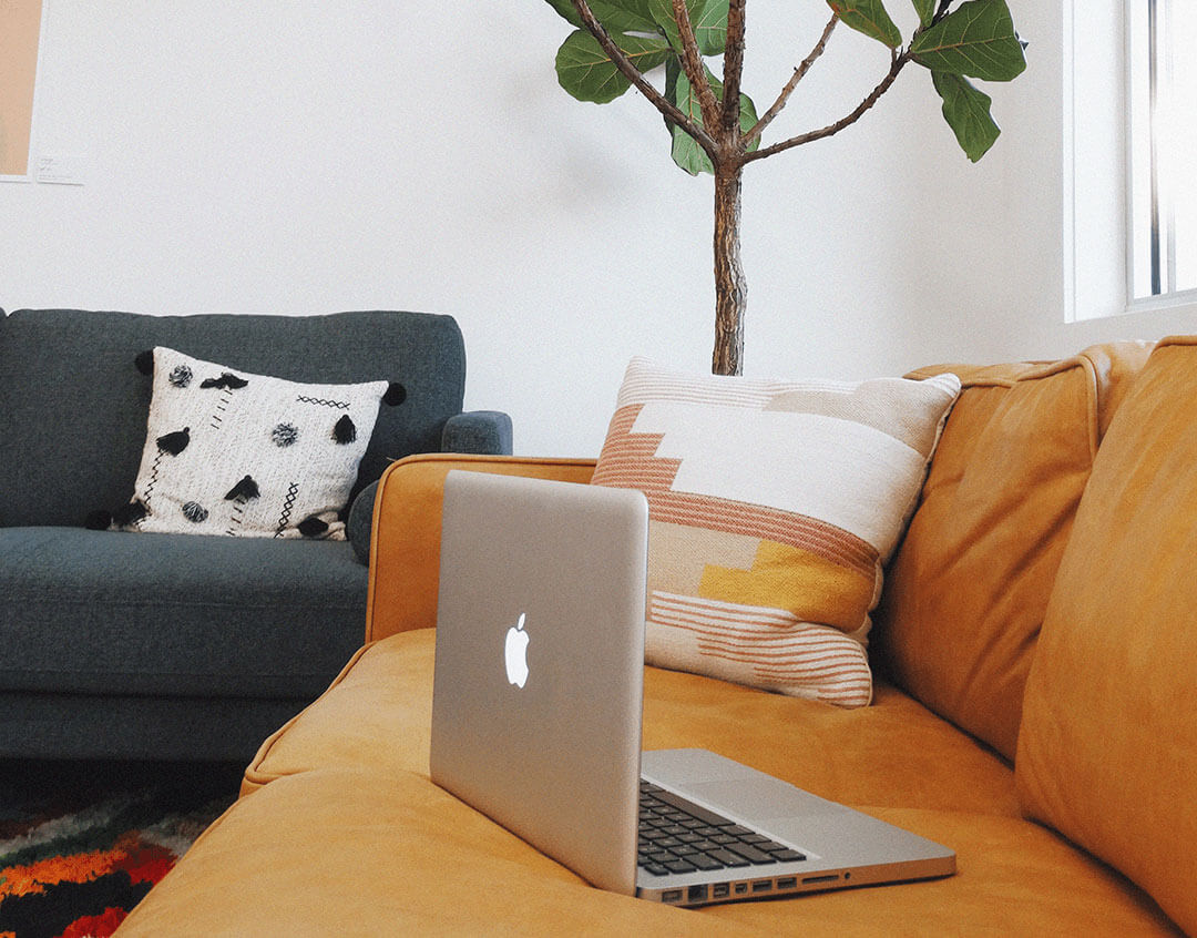 Laptop on Orange Couch Background